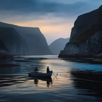 Fisherman casting a net from a small boat with cliffs in the background. - Image 2