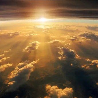 Golden sun setting over dramatic clouds seen from airplane window - Image 4