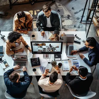 Professionals participating in an online workshop using devices. - Image 1