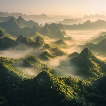 Misty mountains with valleys in fog during sunrise - Image 1