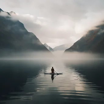 Yogi practicing yoga on a paddleboard at dawn - Image 4