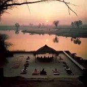 Yoga Students practicing at an outdoor ashram by the Ganges river during sunrise - Image 3