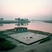 Yoga Students practicing at an outdoor ashram by the Ganges river during sunrise - Image 4