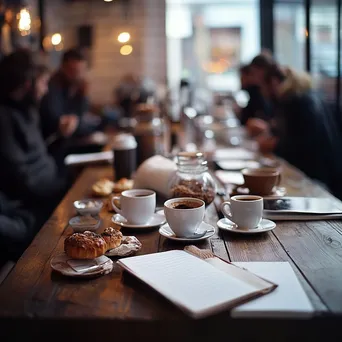 Teams gathering around a table with coffee and pastries for a brainstorming session - Image 1