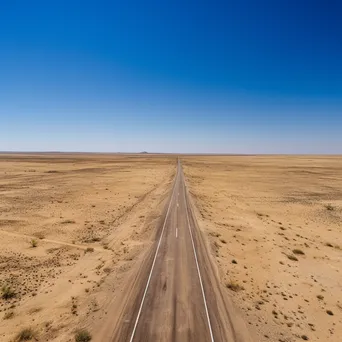 Aerial shot of a deserted highway in the desert - Image 2