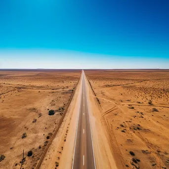 Aerial shot of a deserted highway in the desert - Image 3