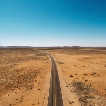 Aerial shot of a deserted highway in the desert - Image 4