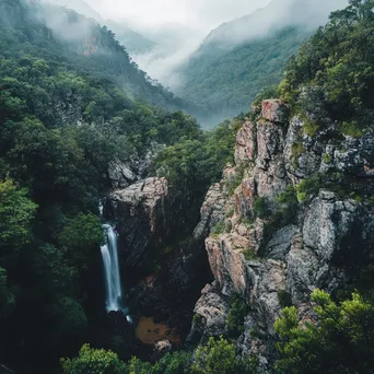 Hidden waterfall in mountain valley surrounded by lush greenery - Image 3