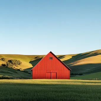 Tall red barn against rolling green hills - Image 1