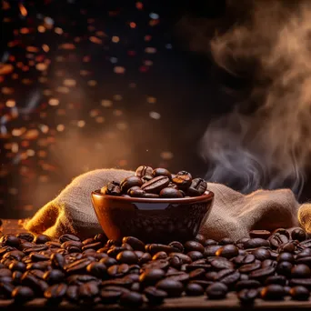 Coffee bag and beans with a steaming cup ready to pour. - Image 1