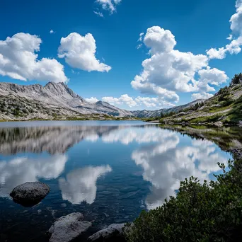 Serene alpine lake with reflections and hiking trails - Image 3