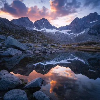 Mountain ridge reflected in a serene alpine lake at sunset - Image 2