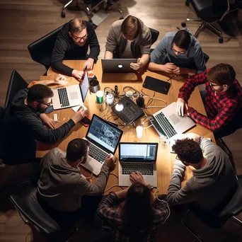 Overhead shot of diverse coders collaborating at a tech meetup - Image 2