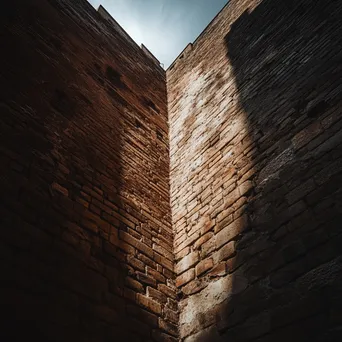 Dramatic view of a historic brick wall structure - Image 1