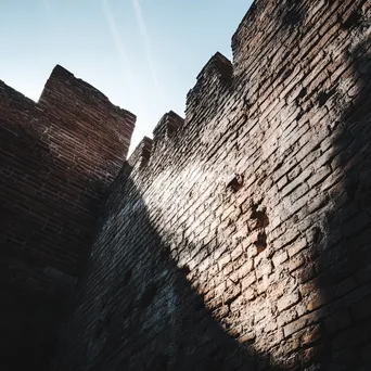 Dramatic view of a historic brick wall structure - Image 4