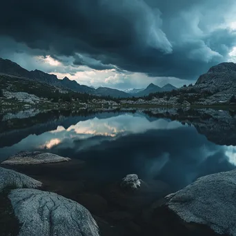 Thunderstorm over tranquil alpine lake reflecting dark clouds - Image 2