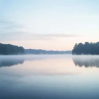 Blurred view of a misty lake at dawn - Image 1