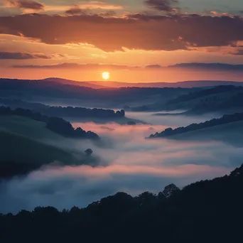 Sunset over a misty valley with warm colors and fog - Image 3