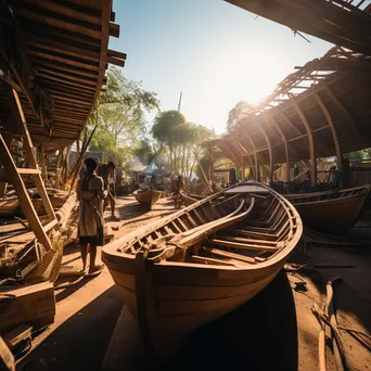 Wide angle view of an outdoor boat-building yard with several unfinished boats - Image 3