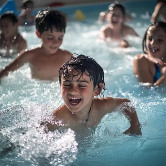 Kids enjoying water aerobics in a shallow pool - Image 2