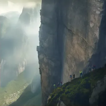 Group of climbers scaling sheer cliff face with breathtaking view of valley - Image 2