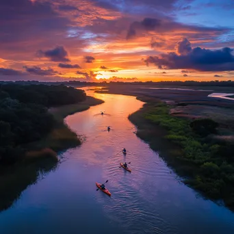 Kayakers paddling in coastal estuary at sunset - Image 1