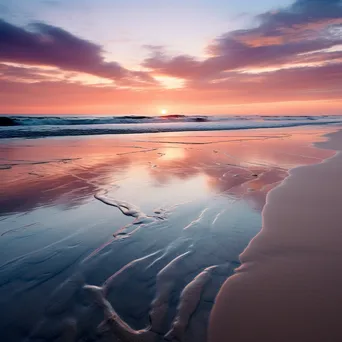 Long exposure photo of a coastal sunset with smooth water and reflective sand - Image 2