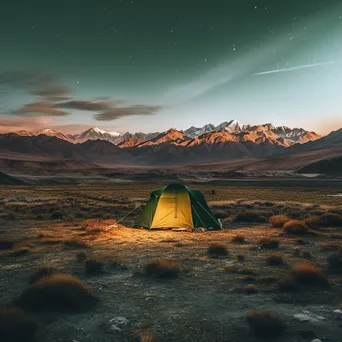 A tent illuminated at twilight in the mountains - Image 2