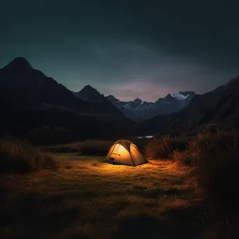 A tent illuminated at twilight in the mountains - Image 3