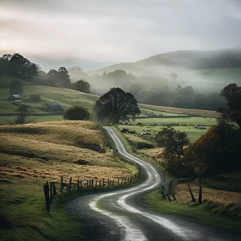 A winding road through misty countryside - Image 1