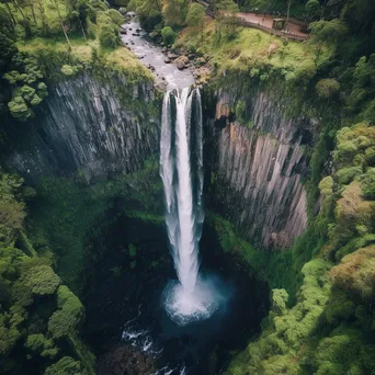 Aerial view of a cascading waterfall and cliffs - Image 1