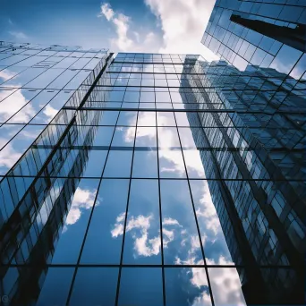 Symmetrical glass building reflecting the sky - Image 1