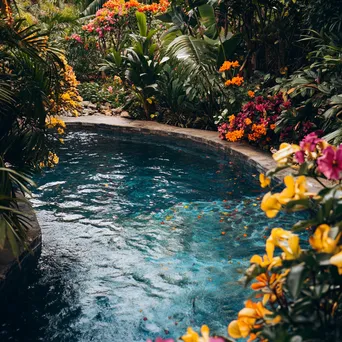 A geothermal pool surrounded by colorful flowers and lush plants. - Image 2