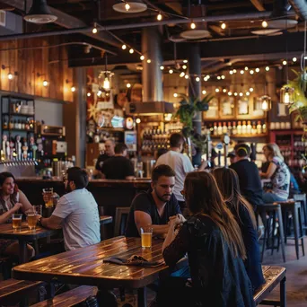 Interior of a local brewery with patrons enjoying beer and rustic decor - Image 2