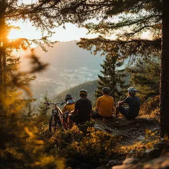 Group of cyclists resting at a scenic viewpoint after a mountain biking trail. - Image 3