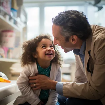 Pediatrician smiling at young patient in bright room - Image 2