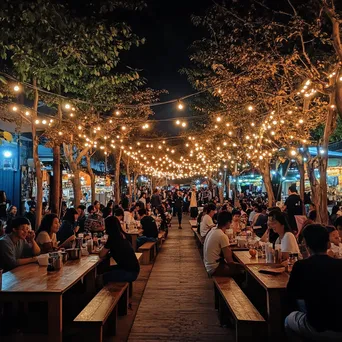 Outdoor street food festival with families sampling various foods - Image 1