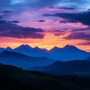 Silhouette of rugged mountain ridges against a colorful sunset - Image 3