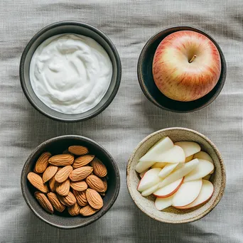 Flat lay of healthy snacks including almonds and apple slices - Image 4