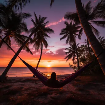 Freelancer working on laptop in hammock at sunset - Image 4