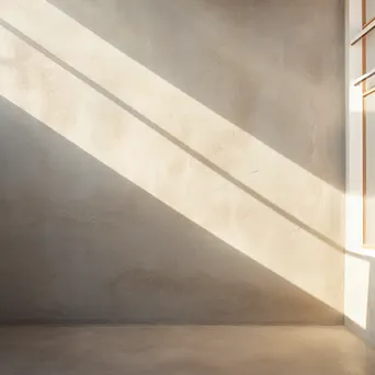 Textured concrete wall with soft shadows from natural light. - Image 2