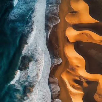 Aerial view of coastal sand dunes with ocean waves - Image 1