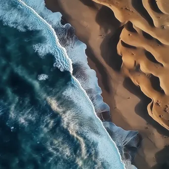 Aerial view of coastal sand dunes with ocean waves - Image 2