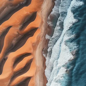 Aerial view of coastal sand dunes with ocean waves - Image 3