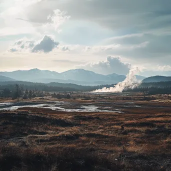 Vast geothermal field with steam and mountains in the background. - Image 2