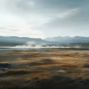 Vast geothermal field with steam and mountains in the background. - Image 4