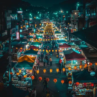 Bustling night market with colorful stalls and lanterns under city lights - Image 1