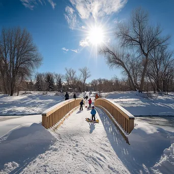 Children tobogganing near a snowy bridge - Image 2