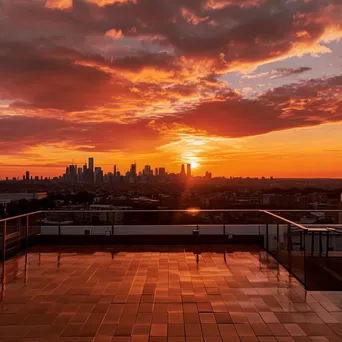 Rooftop terrace overlooking a city skyline during sunset - Image 3