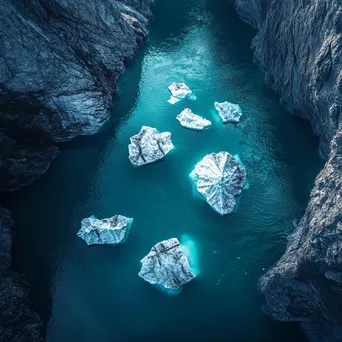 Formation of icebergs in a turquoise glacial bay - Image 4